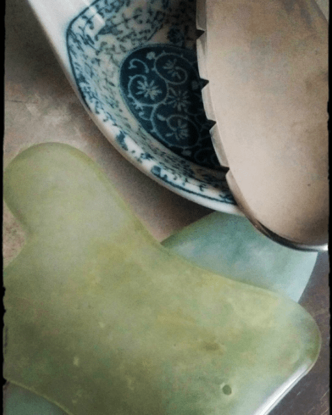 Gua sha tools: jade, porcelain, & metal
